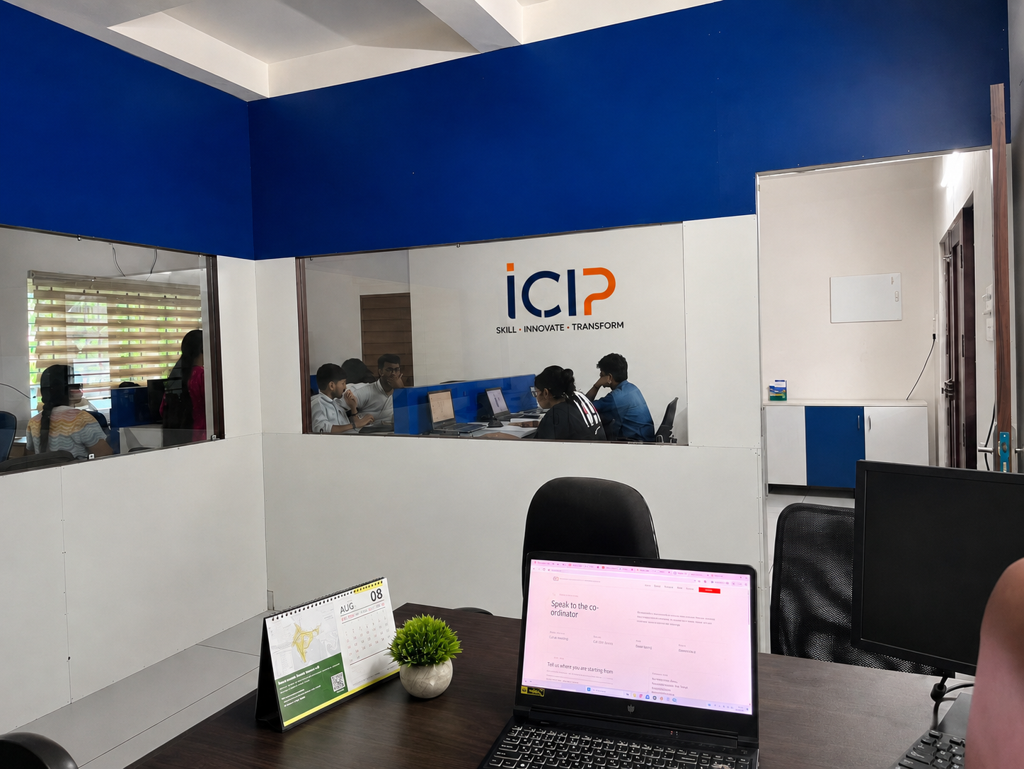 Inside the ICIP training centre at Geospatial Campus, Kakkanad, with the ICIP Skill, Innovate, Transform signage and staff at work.
